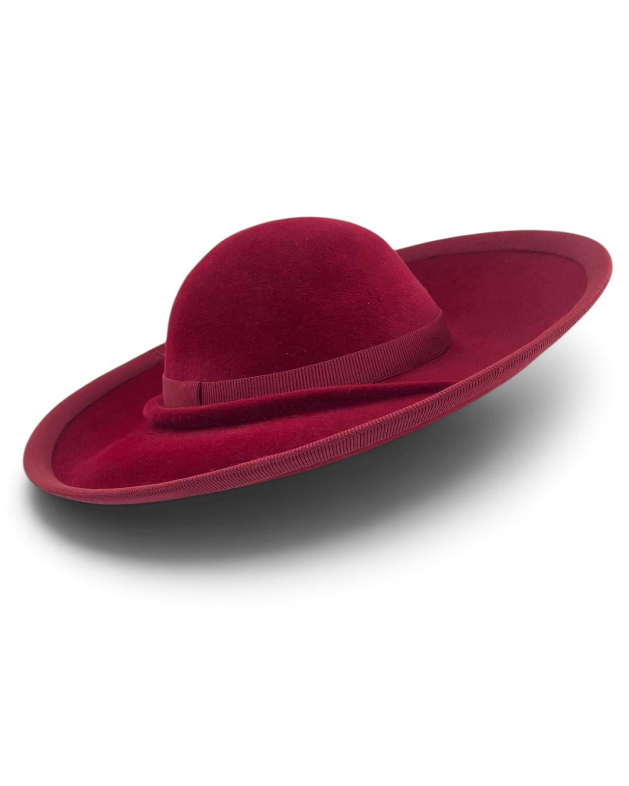Upturned brim of the deep burgundy felt hat showing the bound grosgrain edge and pleated detail, occasion hat handmade in London