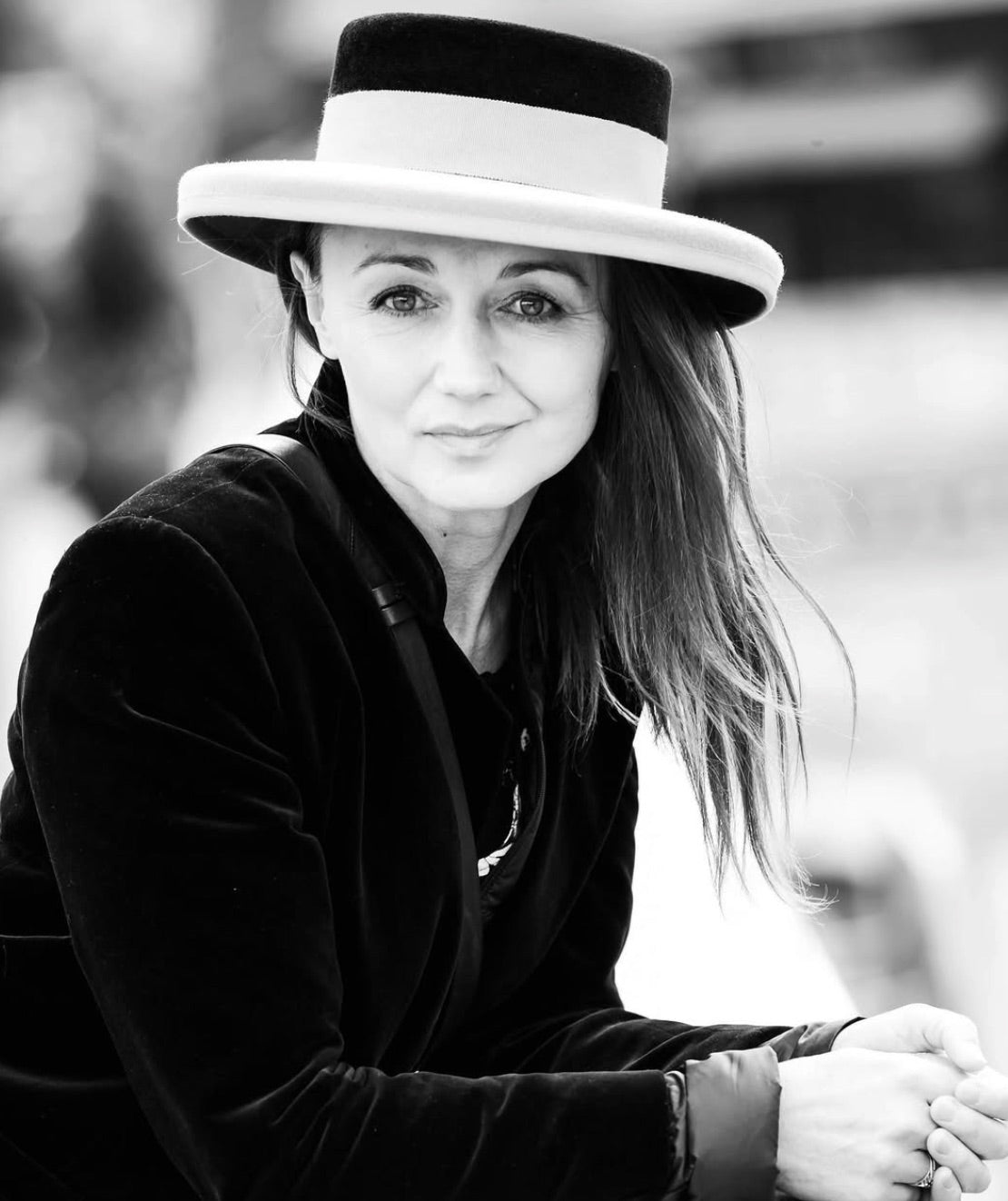Black and white portrait of a woman in a boater with a black crown and pale brim