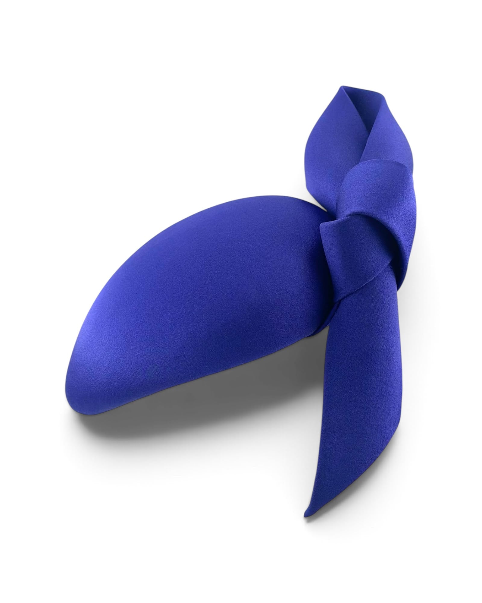 Electric cobalt blue satin cocktail hat with a sculptural hand-modelled knot, handmade in London