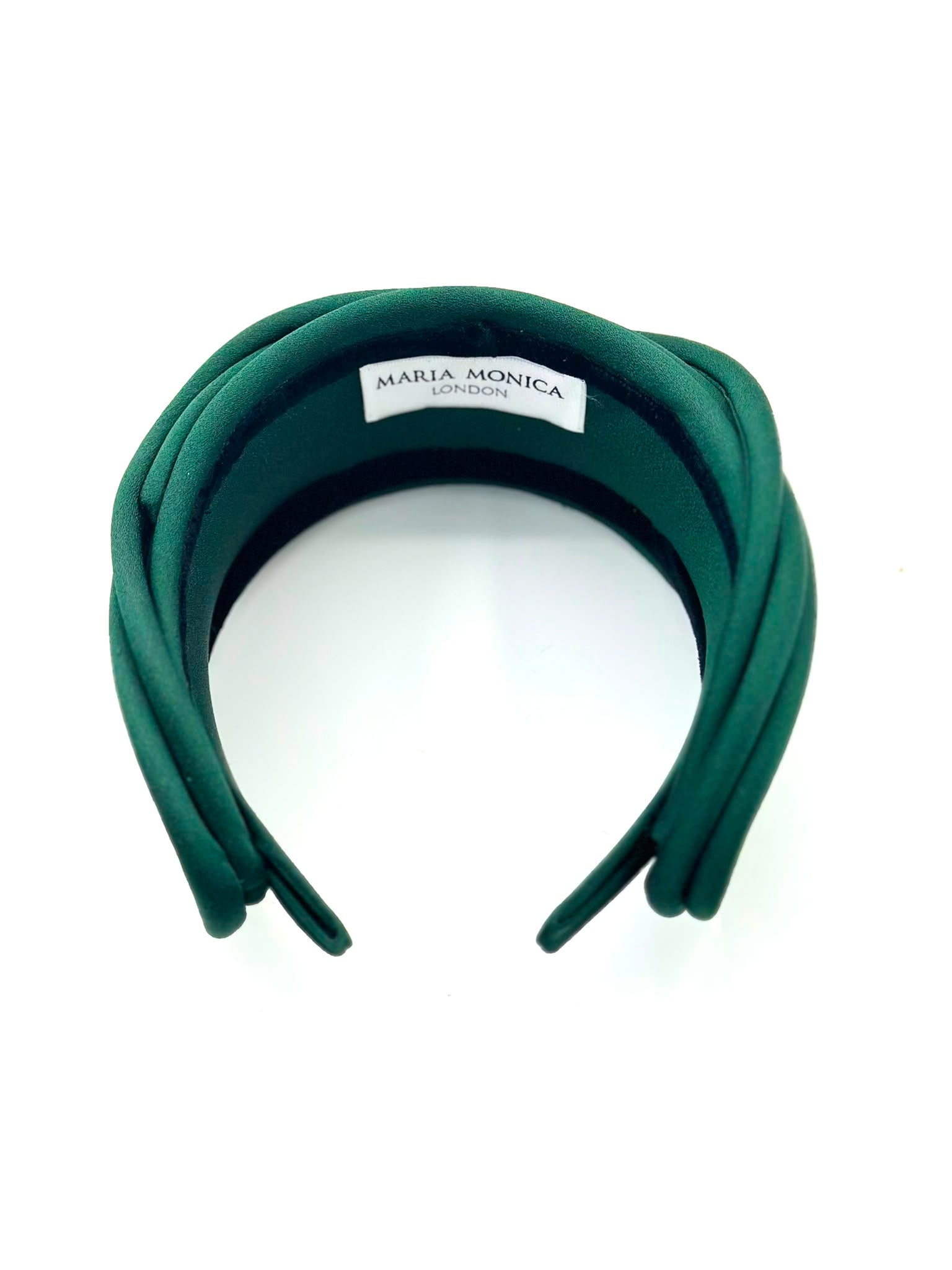 Emerald green satin headband seen from above with the Maria Monica London label stitched inside the band