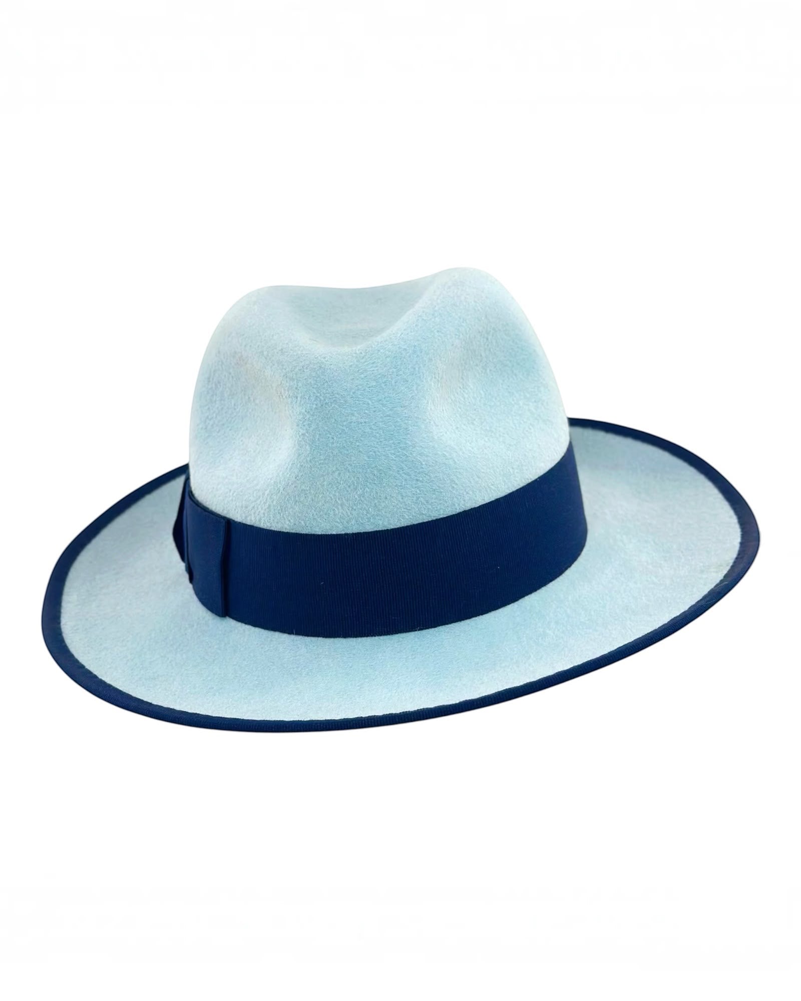 Ice blue felt fedora with a deep navy grosgrain band and bound brim, handmade in London by couture milliner Maria Monica London