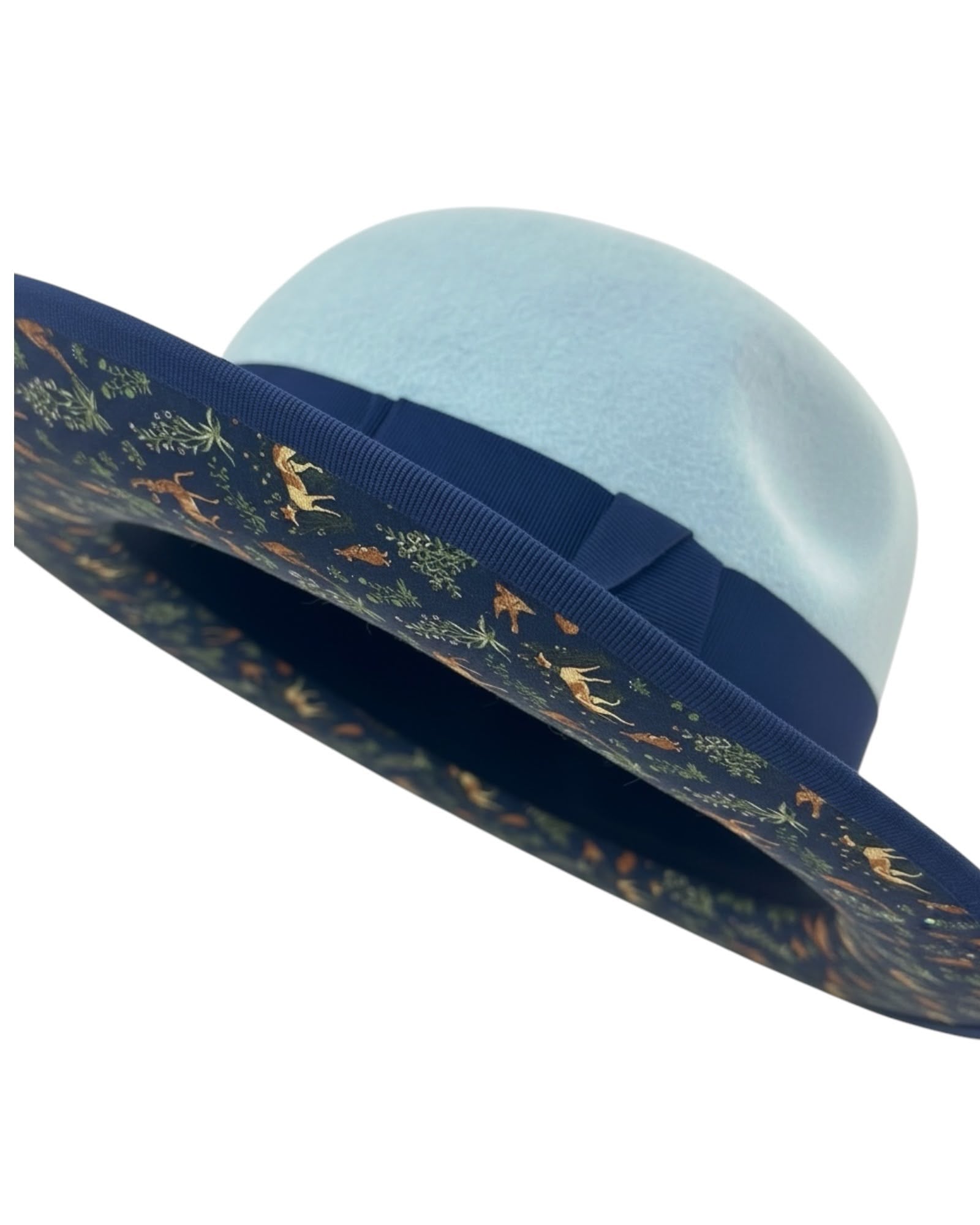 Close detail of the navy silk underbrim with its woodland animal motif inside the ice blue felt fedora, handmade in London