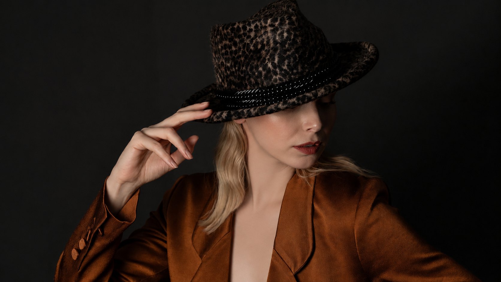 Leopard print felt fedora with a studded band, worn with a tan satin jacket, Maria Monica London