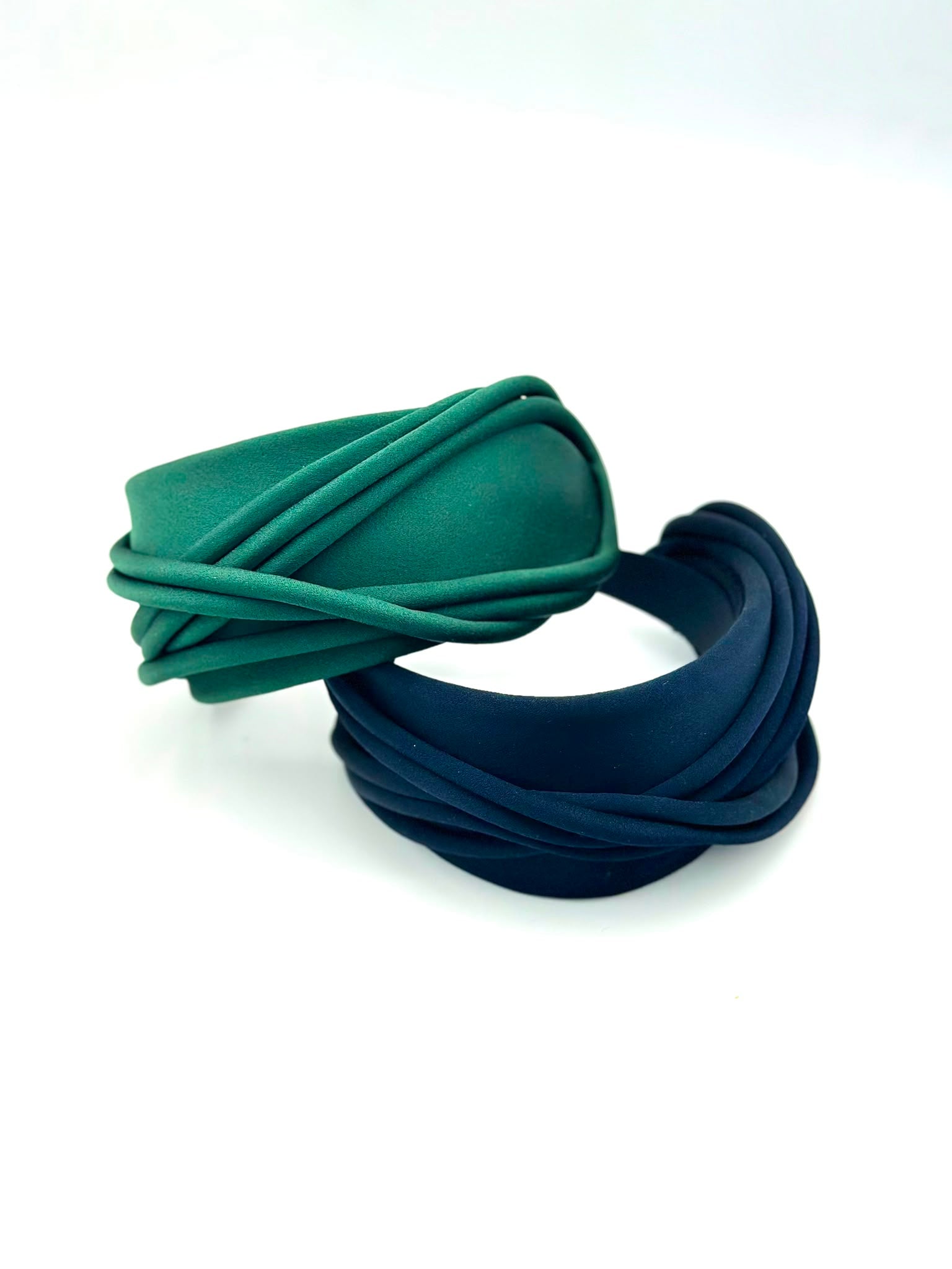 Two wide satin headbands wrapped in piping, one emerald green and one navy, Maria Monica London