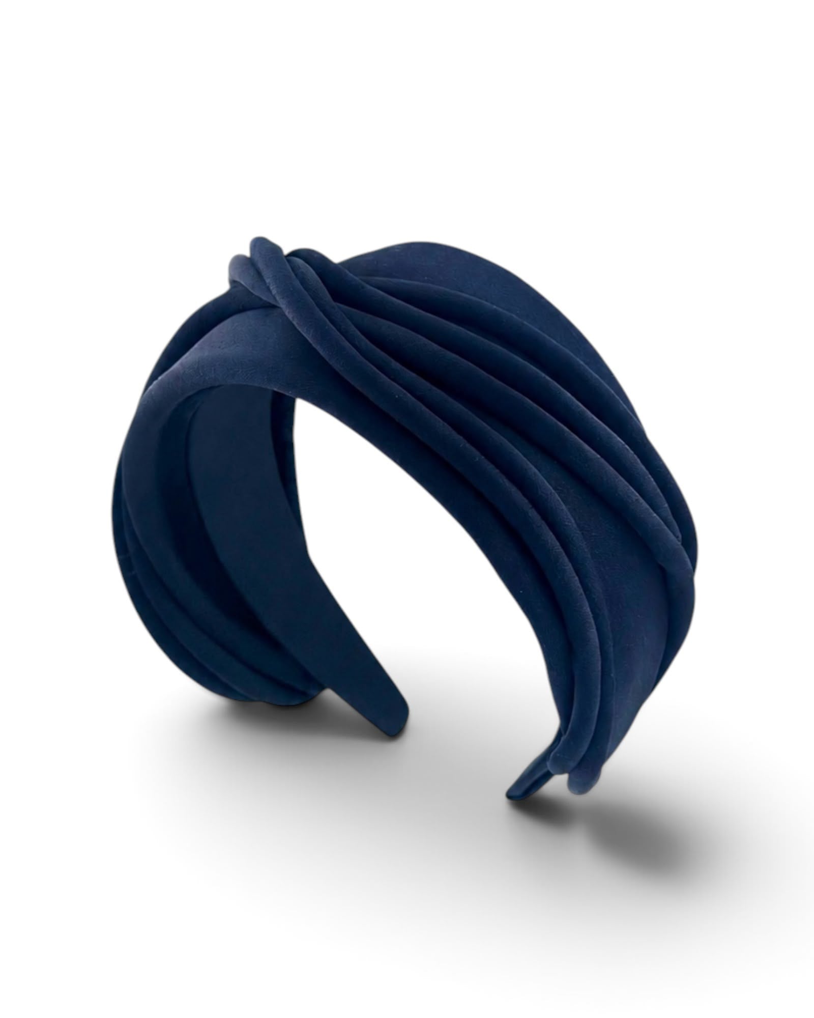 Navy satin headband wrapped in loops of piping across a wide band, angled view, Maria Monica London