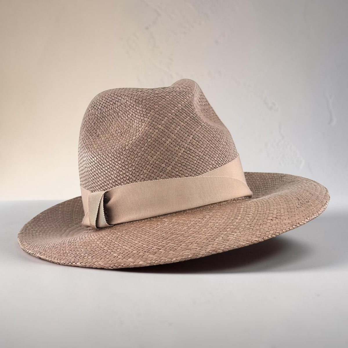Cappuccino panama straw trilby with a wide grosgrain band and flat bow, side view, Maria Monica London