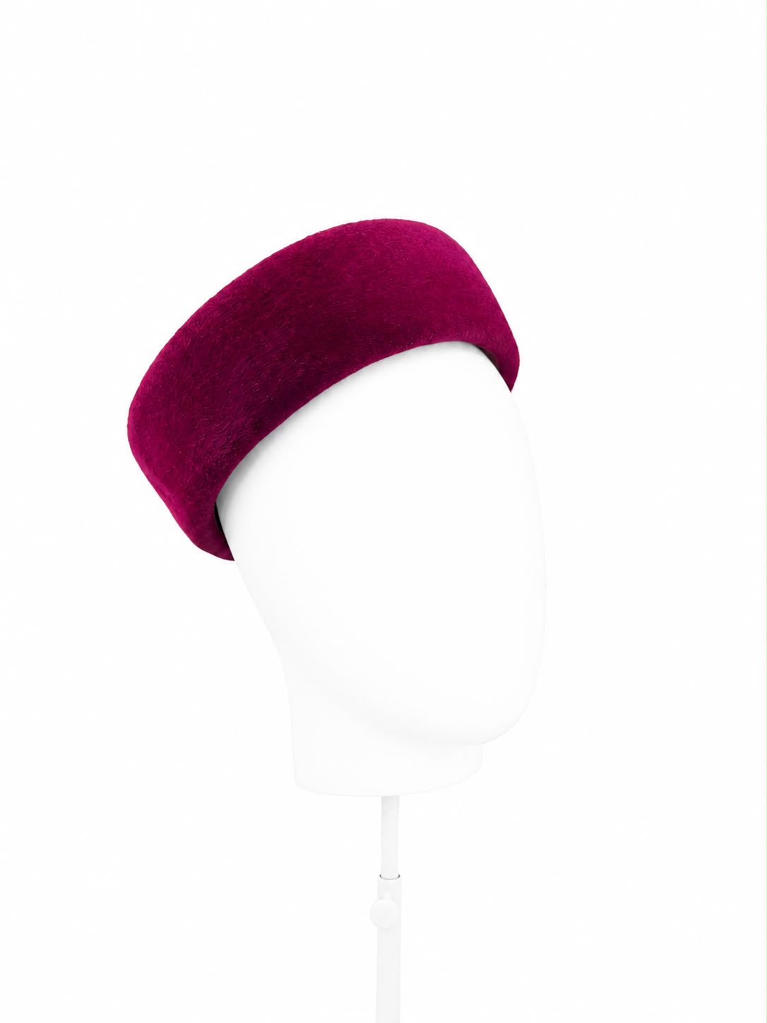 Rich berry felt Jackie-style pillbox hat on a stand, handmade in London by Maria Monica London