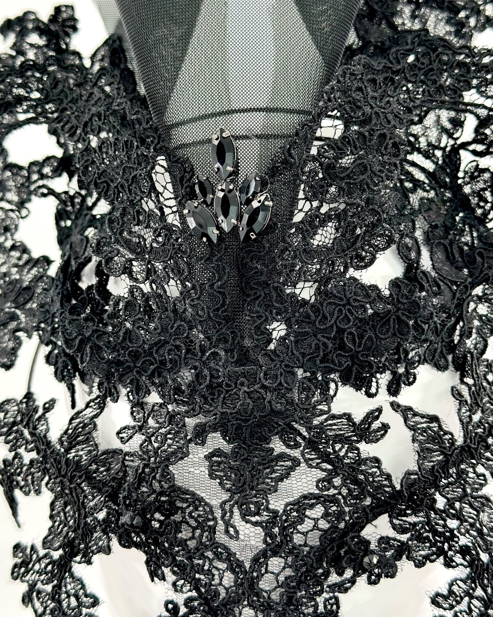 Close detail of black lace and crinoline with a cluster of black crystals at the centre, Maria Monica London