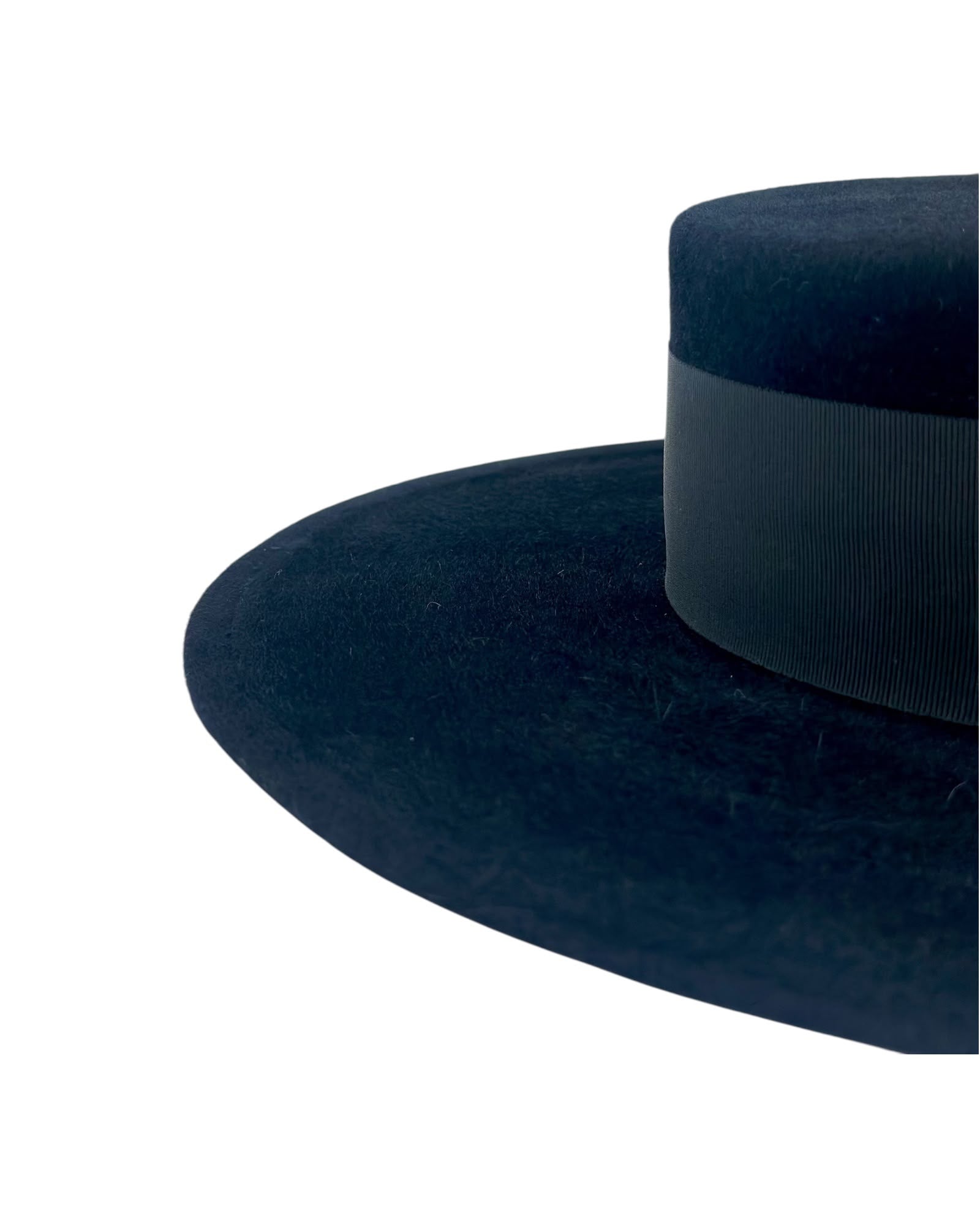 Close detail of the black velvet felt brim edge and the ribbed tonal grosgrain band, handmade in London by a couture milliner