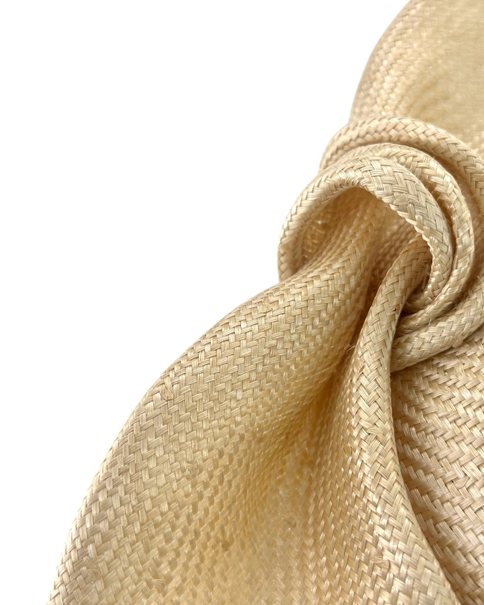 Close view of pale champagne parasisal straw weave at the knot of the bow, Maria Monica London