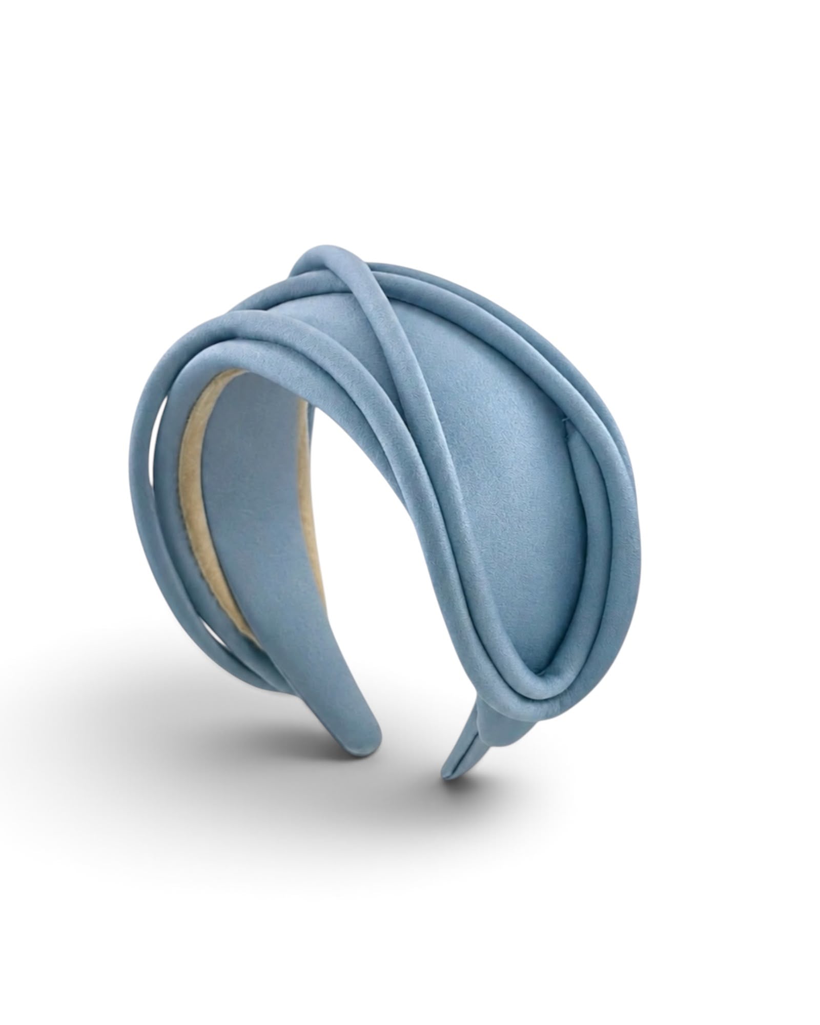 Pale blue satin headband with loops of piping sweeping across the wide band, Maria Monica London