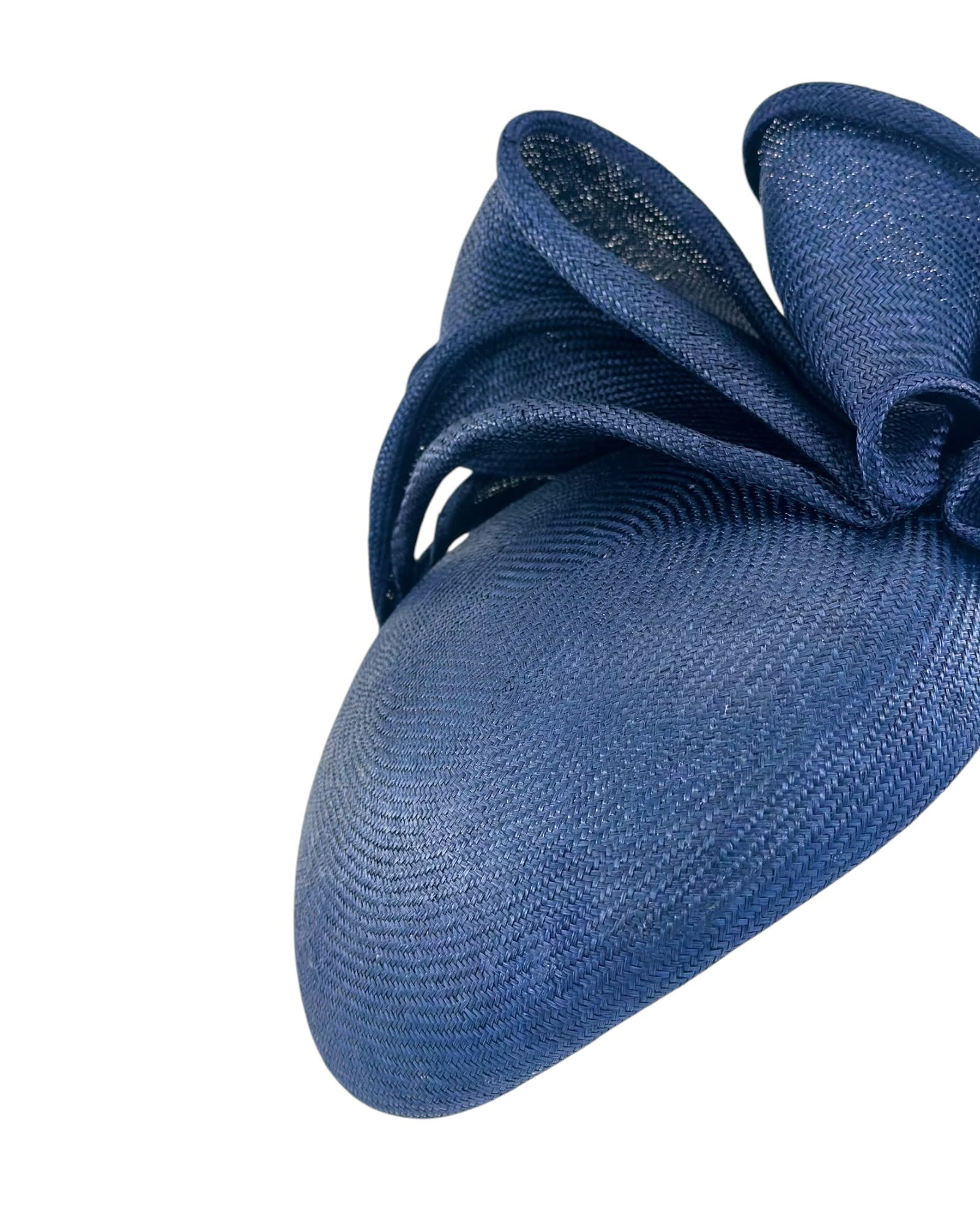 Close view of the navy parasisal weave and the sculpted straw bow on the cocktail hat