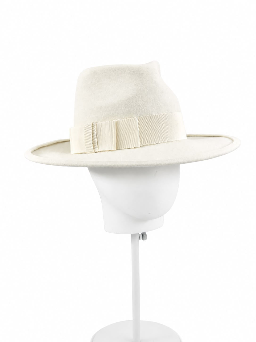 Porcelain cream felt fedora worn on a head block, with a wide brim and tonal grosgrain bow, Maria Monica London