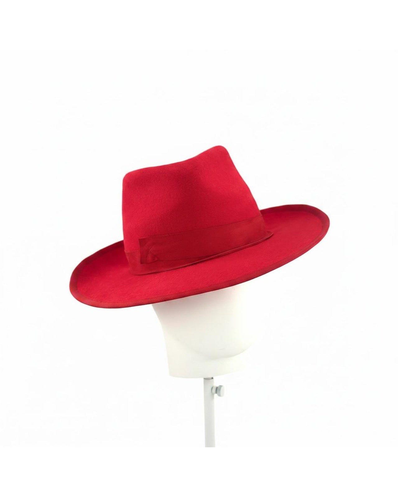 Scarlet red felt trilby shown on a block from an angle, hand blocked in London by Maria Monica London