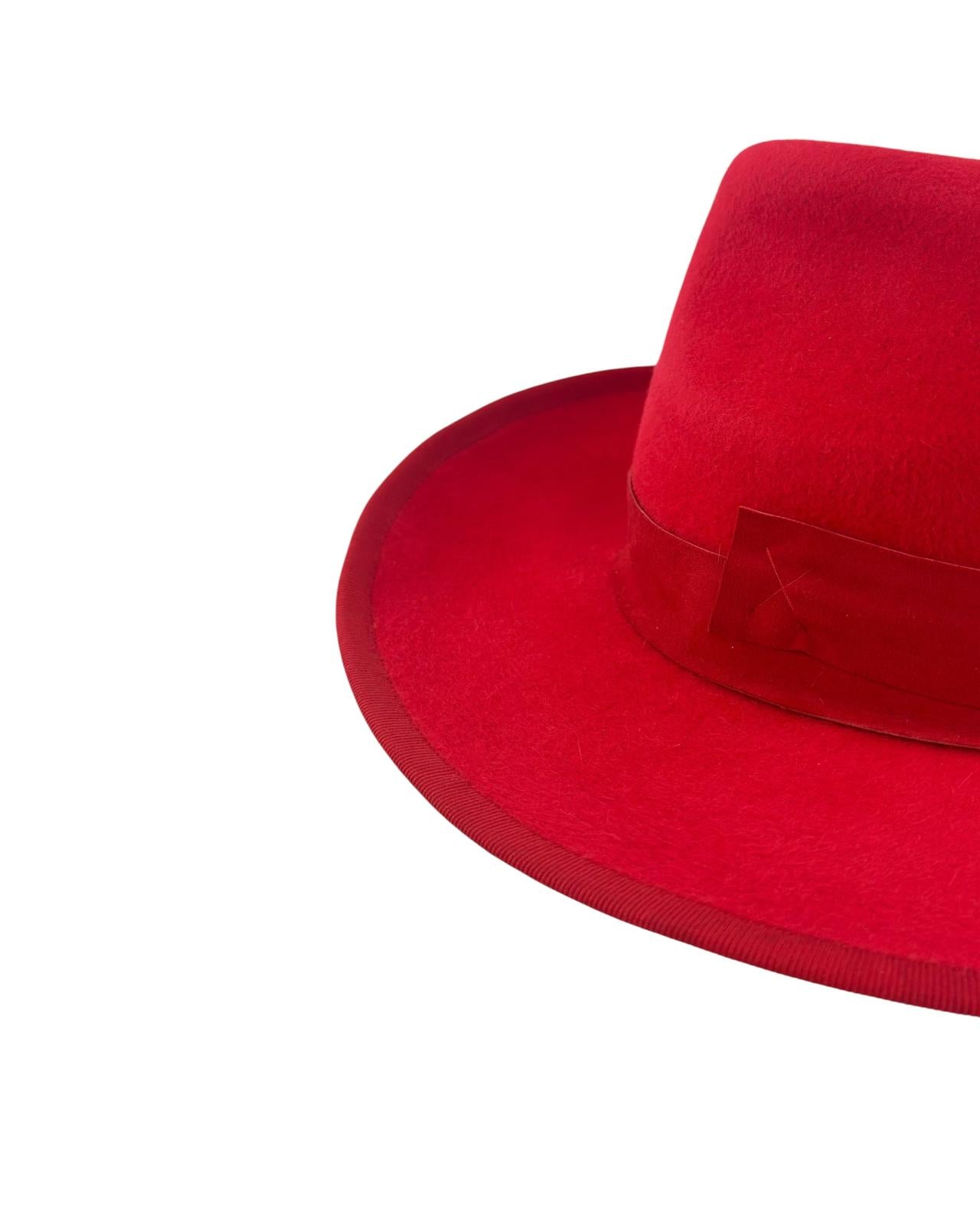 Close detail of the suede band and the tonal red edging on the scarlet felt trilby, handmade in London