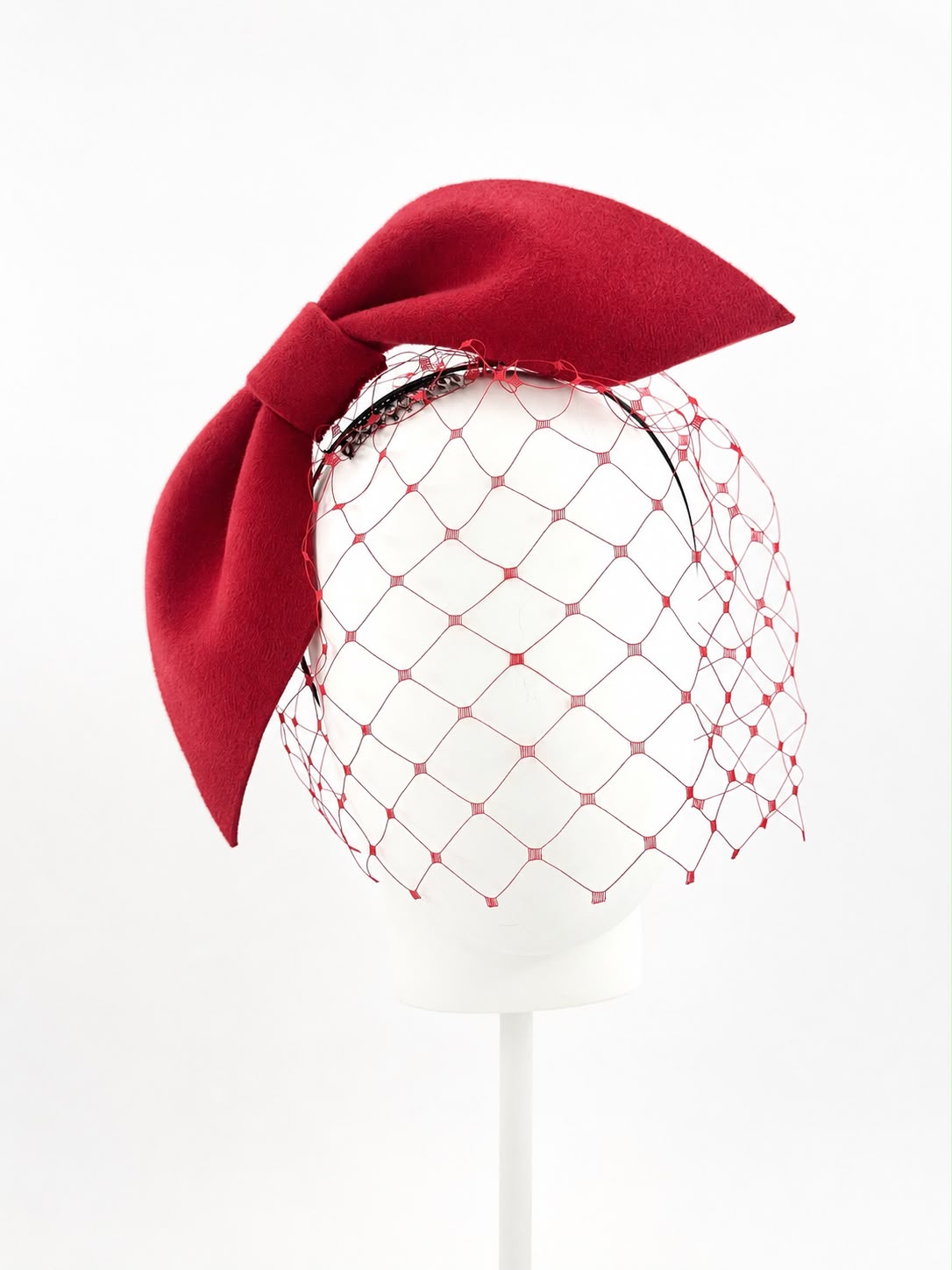 Sculpted felt bow headpiece in scarlet red with tonal veil, Maria Monica London
