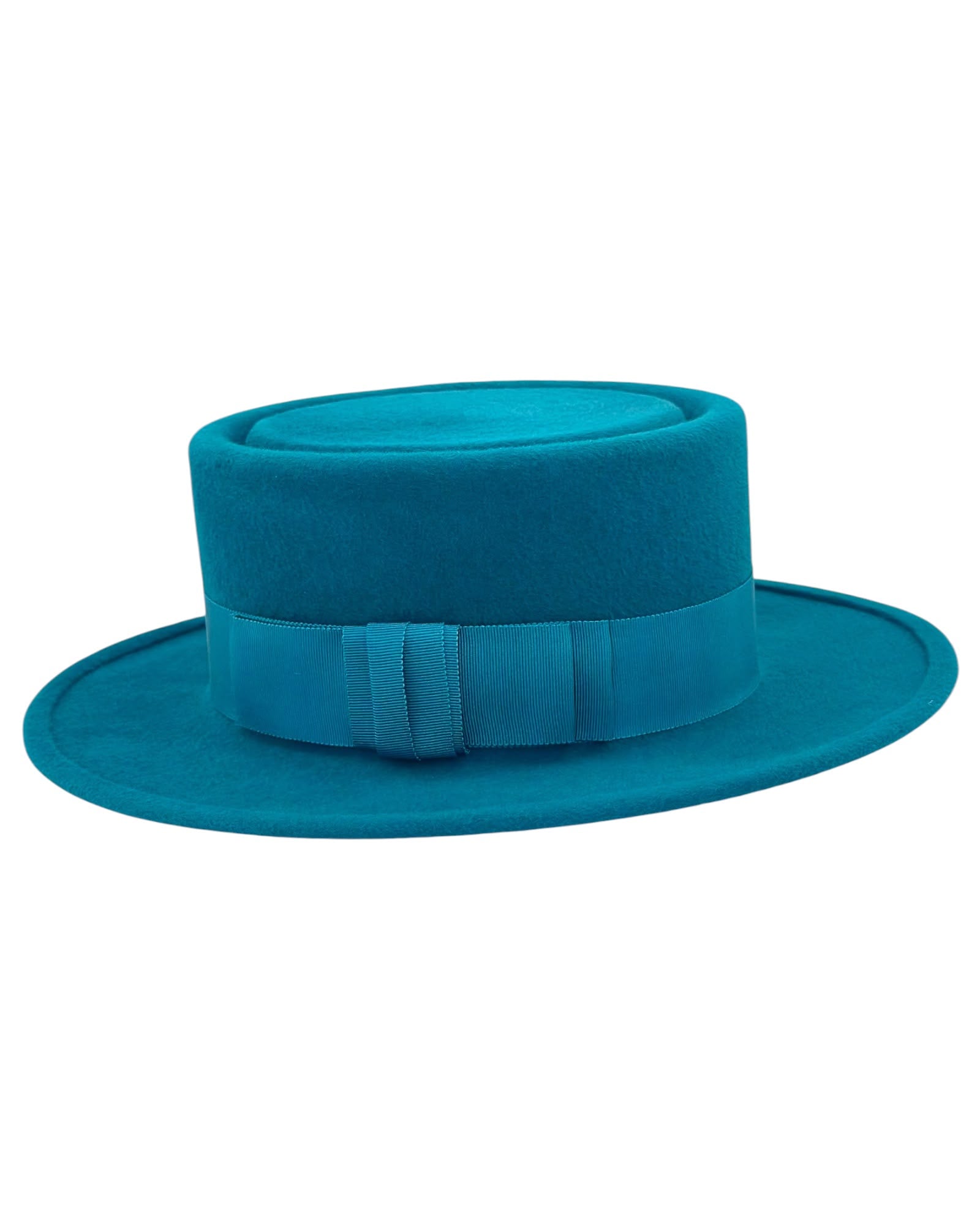 Side view of the turquoise felt boater showing the narrow brim line and the grosgrain ribbon bow, couture millinery handmade in London